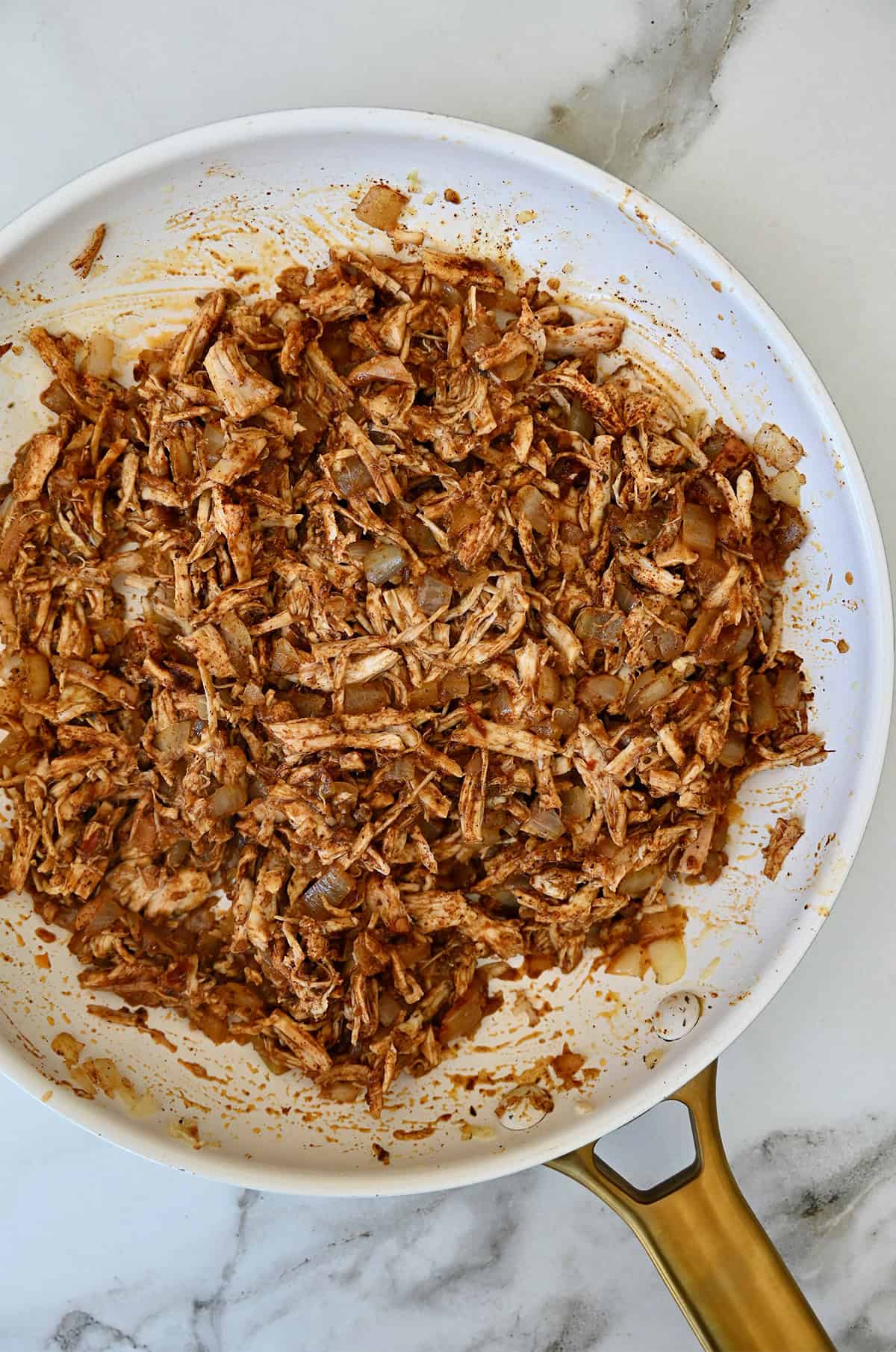 Chicken enchilada filling in a skillet. 