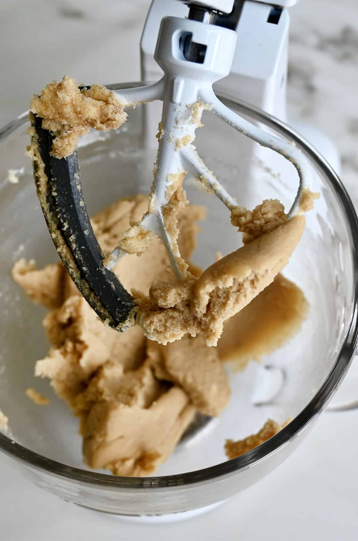 Creamed butter with white and brown sugars in a stand mixer bowl with the paddle attachment.